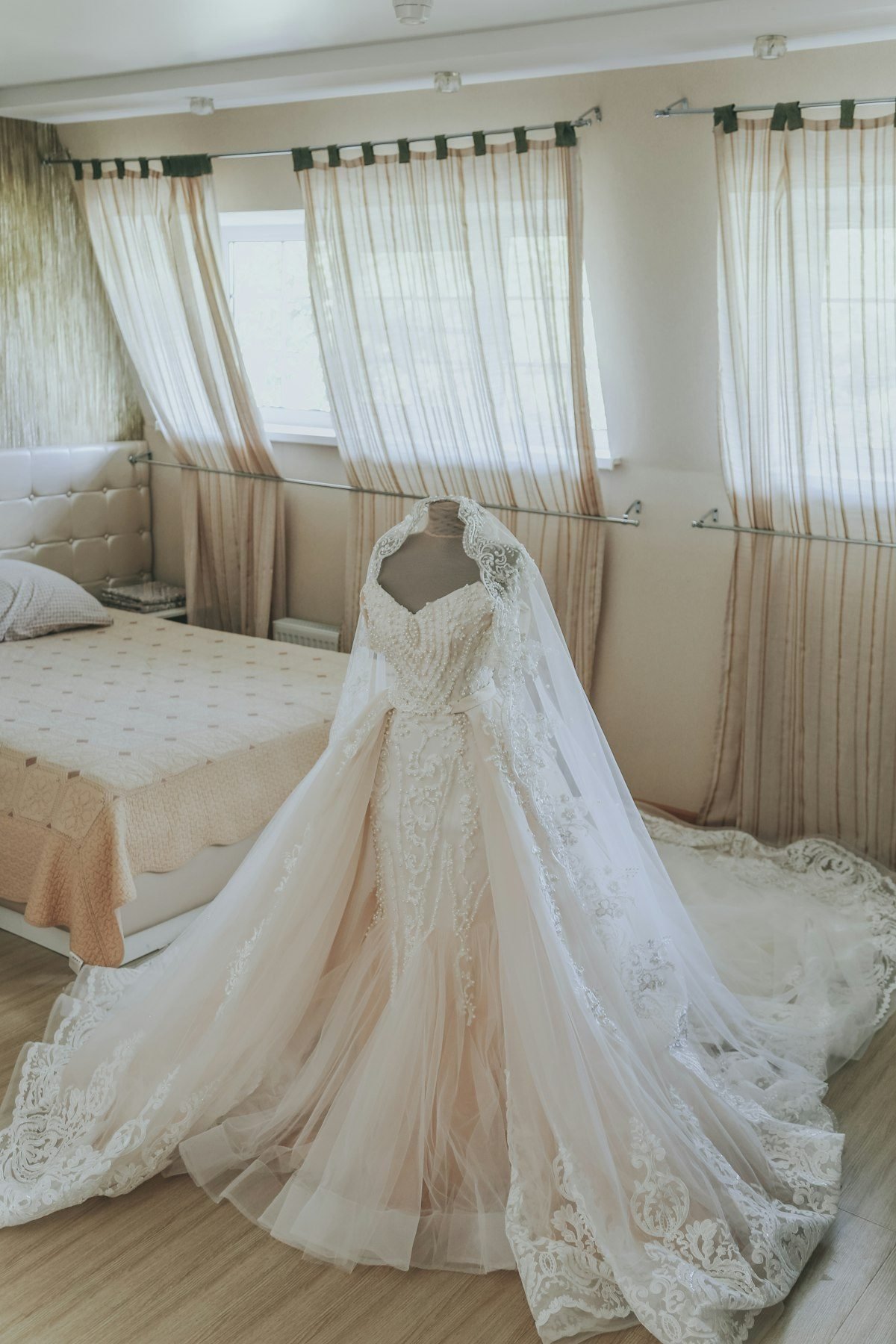 A couture bridal gown with lace veil prepared in the Bloom bridal suite