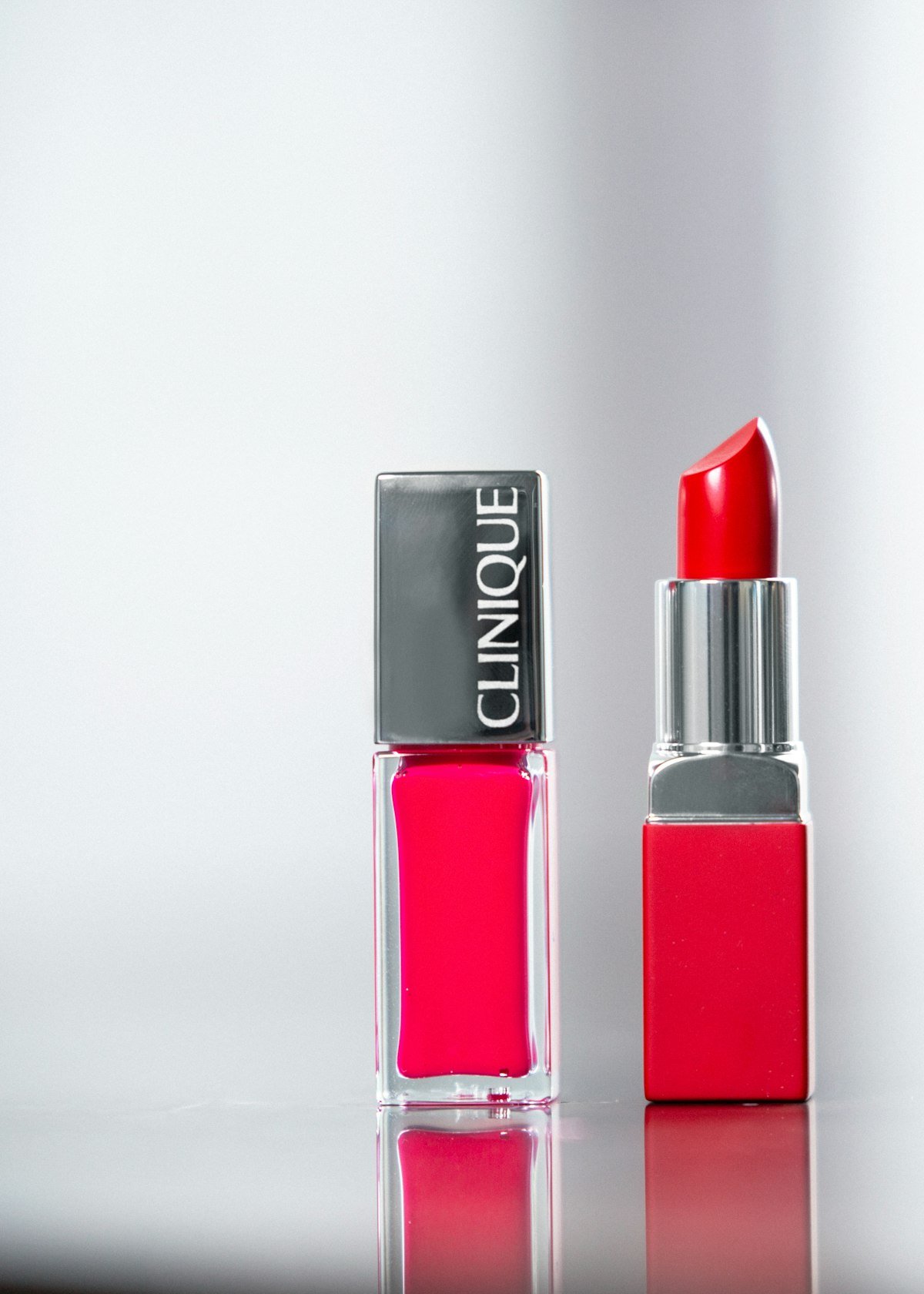 Rose-pink nail lacquer bottle beside a matching lipstick at Bloom